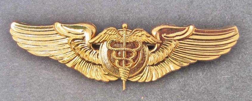 USAAF ARMY AIR CORPS FLIGHT SURGEON WING: Measures 3 3/16" wide by 15/16" tall. The reverse is maker marked: NS Meyer New York. Has a thin horizontal pin back with a locking catch. Two piece brass construction.