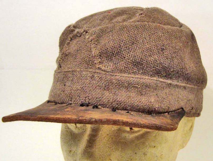 CONFEDERATE STATES ARMY CIVIL WAR ARMY CSA MILITARY: The body is a grey gunny sack cloth material. The interior has a black cotton lining. The front has a brown leather bill that is hand sewn on. Shows use and wear. Scarce.