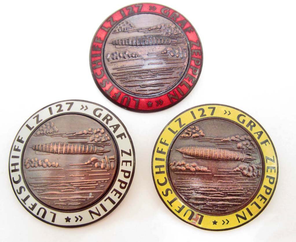 LOT OF 3 GERMAN NAZI GRAF ZEPPELIN LZ 127 AIR SHIP: Measures 1 3/4" in diameter. Maker marked FLL. All three have a thin horizontal pin back. Two piece copper construction with enamel.