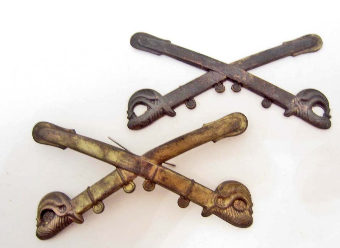 LOT OF 2 US CIVIL WAR UNION ARMY CAVALRY ENLISTED MANS: US Civil War Union Army Cavalry Enlisted Mans Kepi Cap Badges. They measure 3 3/8" wide by 1 ?" tall. Each one has a pair of crossed cavalry sabers. Stamped brass construction with two wire prongs mou