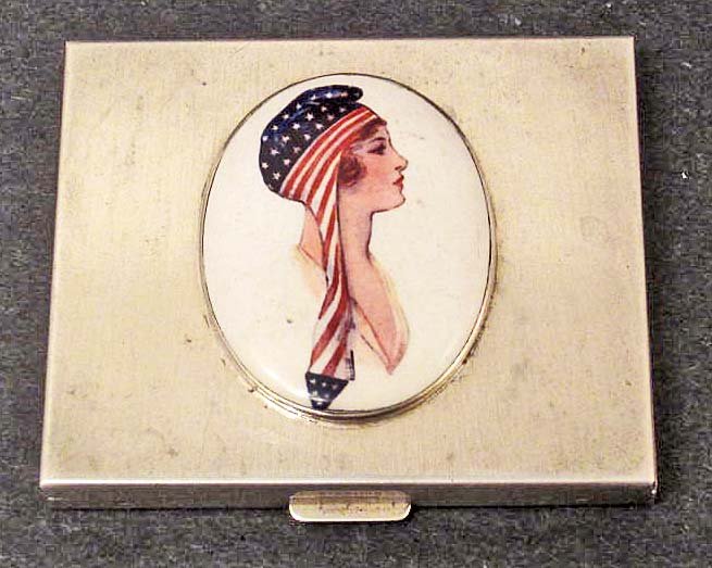 STERLING SILVER COMPACT W/ ENAMELED EMBLEM ON LID: Enameled piece is a beautiful Woman w/ a scarf on her head showing Stars & Stripes. Compact is approx. 2.75" by 2.25"
