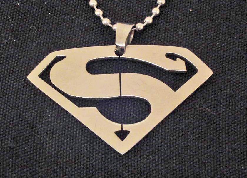 SUPERMAN / SUPERGIRL STAINLESS STEEL SYMBOL PENDANT: With chain. Measures 1-3/4" x 1-1/4"