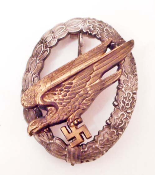 GERMAN NAZI LUFTWAFFE PARATROOPER FALLSCHIRMJAGER BADGE: . The reverse side is maker marked 'B & N L'. Has a thin vertical pin back. Two piece two domed rivet construction.
