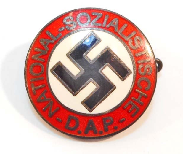 GERMAN NAZI NSDAP ENAMELED PARTY BADGE: Measures 1" diameter. Reverse side is maker marked 'RZM M1/129'. Thin horizontal pin back. Nickel construction with red, white and black enamel.