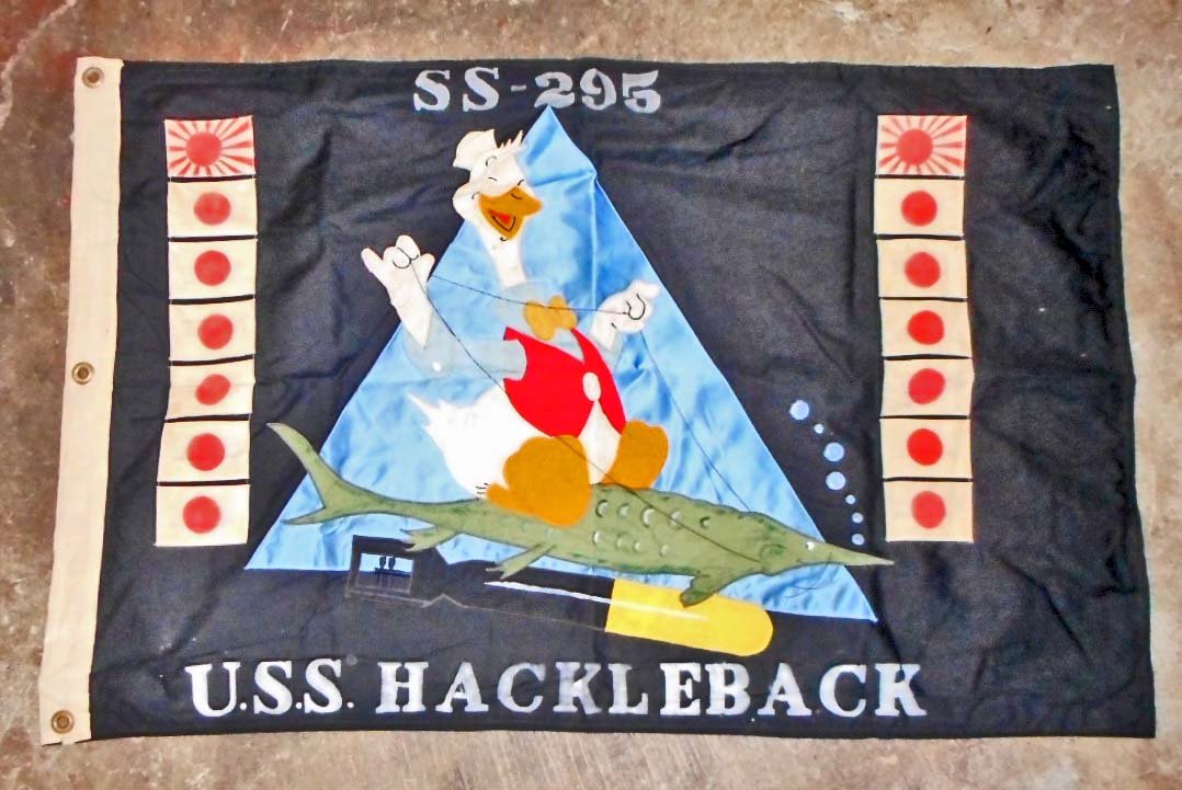 USN NAVAL USS HACKLEBACK SS-295 SUBMARINE FLAG: Measures 27-1/2" wide by 43-1/4" long. The front shows a duck riding a fish with a torpedo below. Has the kills of each ship on both sides of the duck. It reads 'SS-295 USS Hackleback'. Has a white co