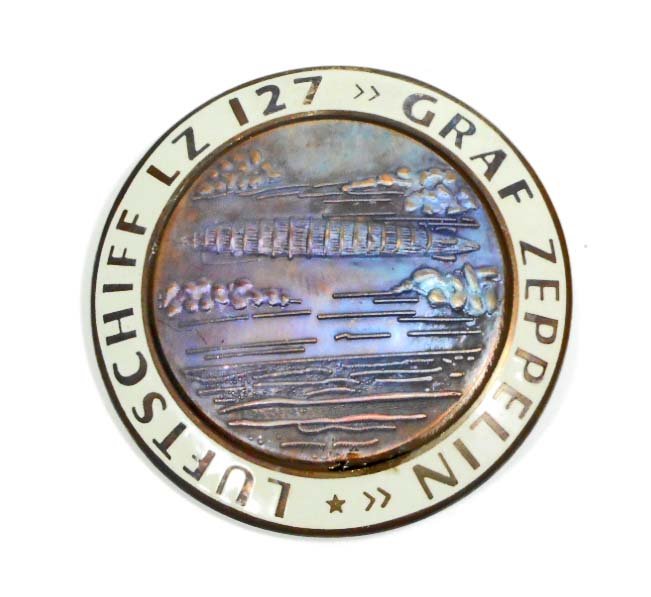 GERMAN NAZI GRAF ZEPPELIN LUFTSCHIFF LZ127 AIR SHIP: Measures 1 3/4" in diameter. The reverse side is maker marked 'FLL'. Has a thin horizontal pin back. Two piece copper construction with white enamel.