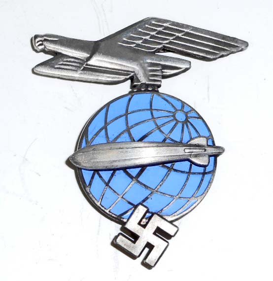GERMAN NAZI ZEPPELIN AIR SHIP OFFICERS VISOR CAP BADGE: Measures 1 1/2" wide by 1 3/4" tall. There are three flat prongs on the reverse side for securing to the visor hat. Three piece nickel construction with light blue enamel