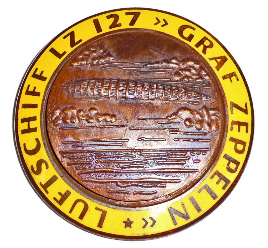 GERMAN NAZI GRAF ZEPPELIN LUFTSCHIFF LZ 127 AIR SHIP: . Measures 1 3/4" in diameter. The reverse side is maker marked 'FLL'. Has a thin horizontal pin back. Two piece copper construction with yellow enamel