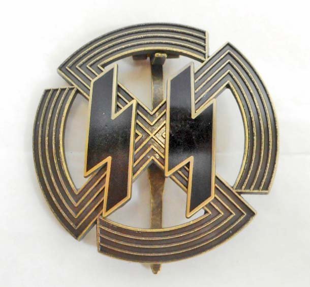 GERMAN NAZI BRONZE WAFFEN SS RUNIC BADGE: Measures 2" in diameter. The reverse side is maker marked 'Richard Sieper & Sohn Ludenscheid RZM M1/25'. Has a wide vertical pin back. Three piece bronze construction with a pair of black enameled lig