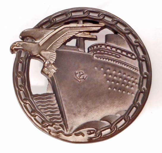 GERMAN NAZI NAVAL BLOCKADE RUNNER BADGE: The reverse side is maker marked 'Fec Otto Placzek Berlin Ausf Schwerin Berlin'. Has a wide vertical pin back