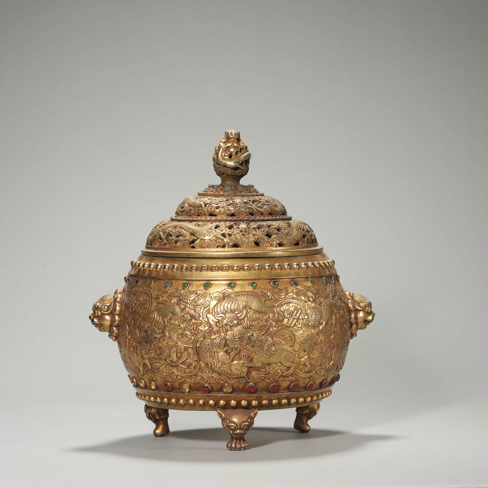 A GILT-BRONZE 'DRAGON AND BEAST MASK' TRIPOD CENSER: A GILT-BRONZE 'DRAGON AND BEAST MASK' TRIPOD CENSER Height: 10 1/4 in. (26 cm)