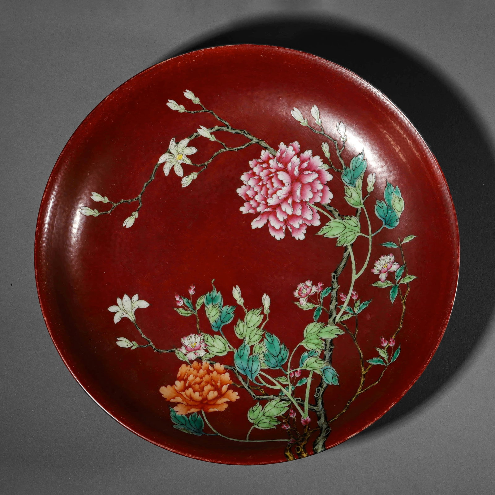 A RED-GLAZED 'FLOWERS' DISH: A RED-GLAZED 'FLOWERS' DISH Height: 1 15/16 in. (5 cm), Diameter: 11 7/16 in. (29 cm)