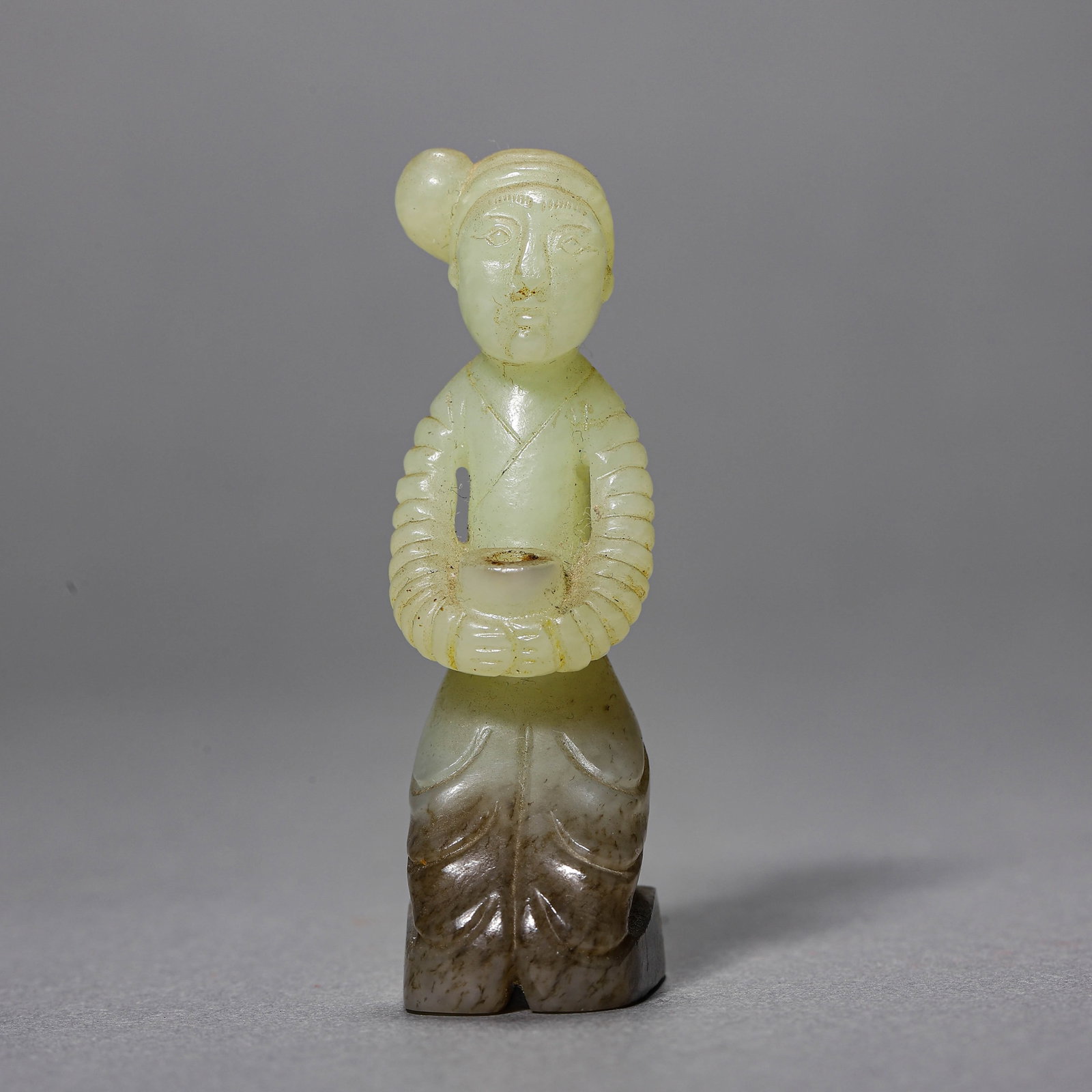 A JADE KNEELING FIGURE: A JADE KNEELING FIGURE Height: 2 3/4 in. (7 cm)