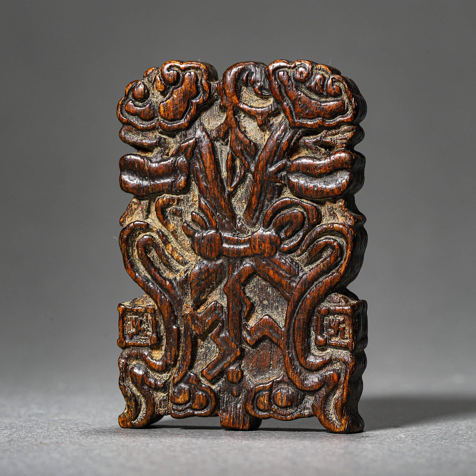 A SINKIANG WOOD PENDANT: A SINKIANG WOOD PENDANT Length: 2 3/8 in. (6 cm), Width: 1 9/16 in. (4 cm)