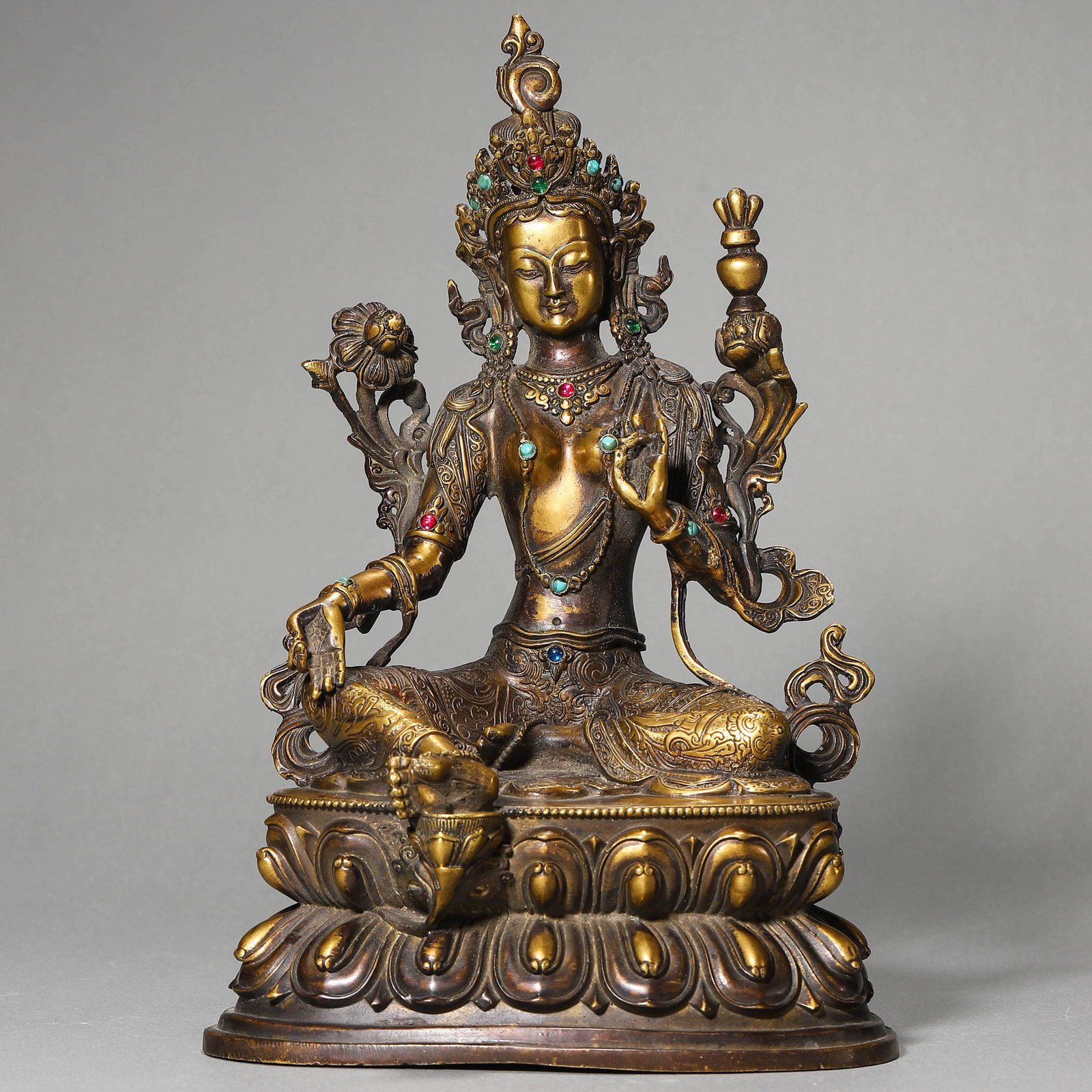 A GILT-BRONZE FOUR-ARMED GUANYIN FIGURE: A GILT-BRONZE FOUR-ARMED GUANYIN FIGURE Height: 20 1/16 in. (51 cm)