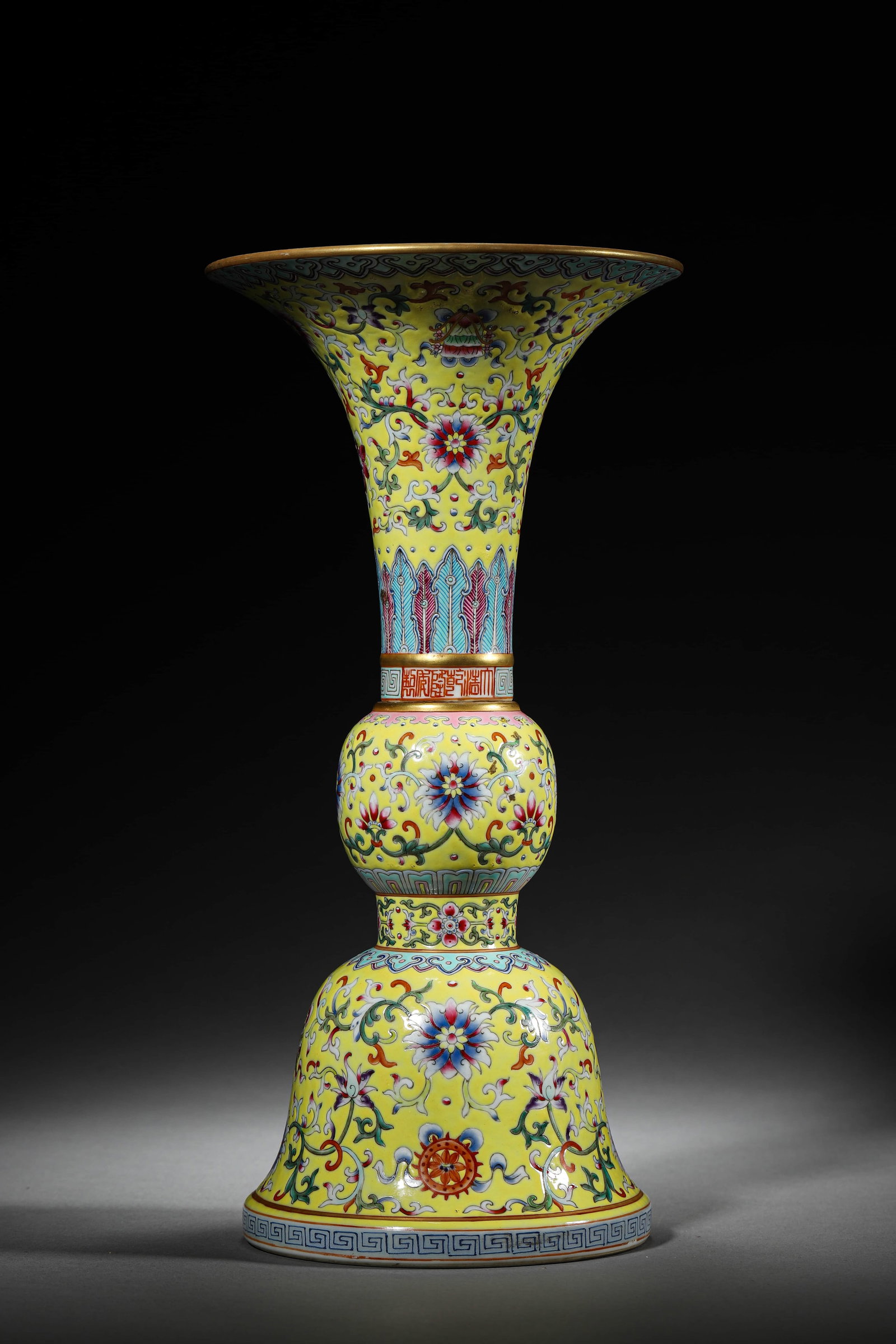 A YELLOW-GROUND FAMILLE ROSE 'FLOWERS' GU VASE: A YELLOW-GROUND FAMILLE ROSE 'FLOWERS' GU VASE Height: 11 3/4 in. (30 cm), Diameter: 5 3/4 in. (14.5 cm)