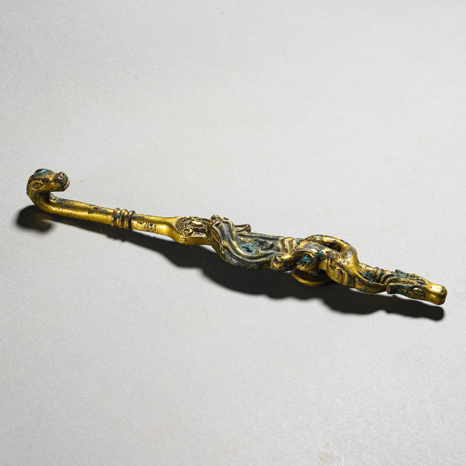 A GILT-BRONZE 'DRAGON' BELT HOOK: A GILT-BRONZE 'DRAGON' BELT HOOK Length: 6 11/16 in. (17 cm)