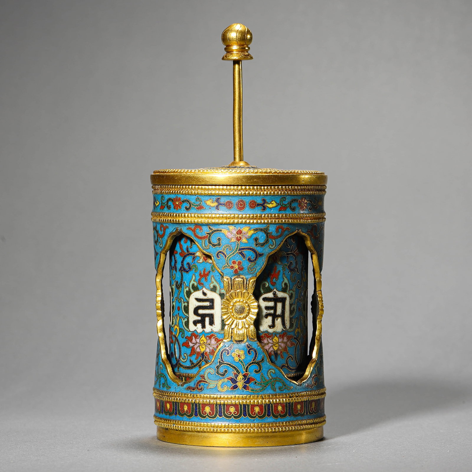 A CLOISONNÉ ENAMEL PRAYER WHEEL: A CLOISONNÉ ENAMEL PRAYER WHEEL Height: 6 7/8 in. (17.5 cm)