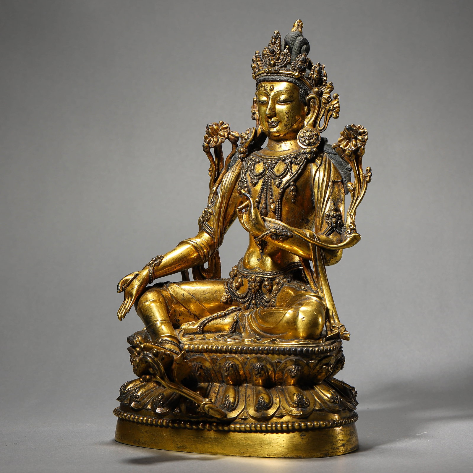 A GILT-BRONZE GREEN TARA FIGURE: A GILT-BRONZE GREEN TARA FIGURE Height: 10 1/8 in. (25.7 cm)