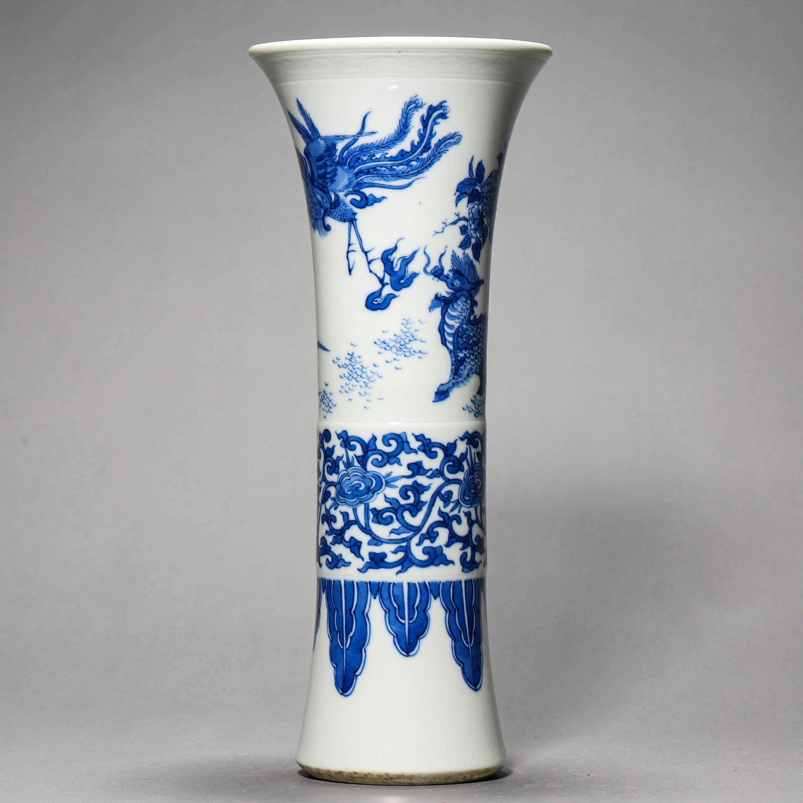A BLUE AND WHITE 'MYTHICAL BEAST' GU VASE: A BLUE AND WHITE 'MYTHICAL BEAST' GU VASE Height: 10 5/8 in. (27 cm)
