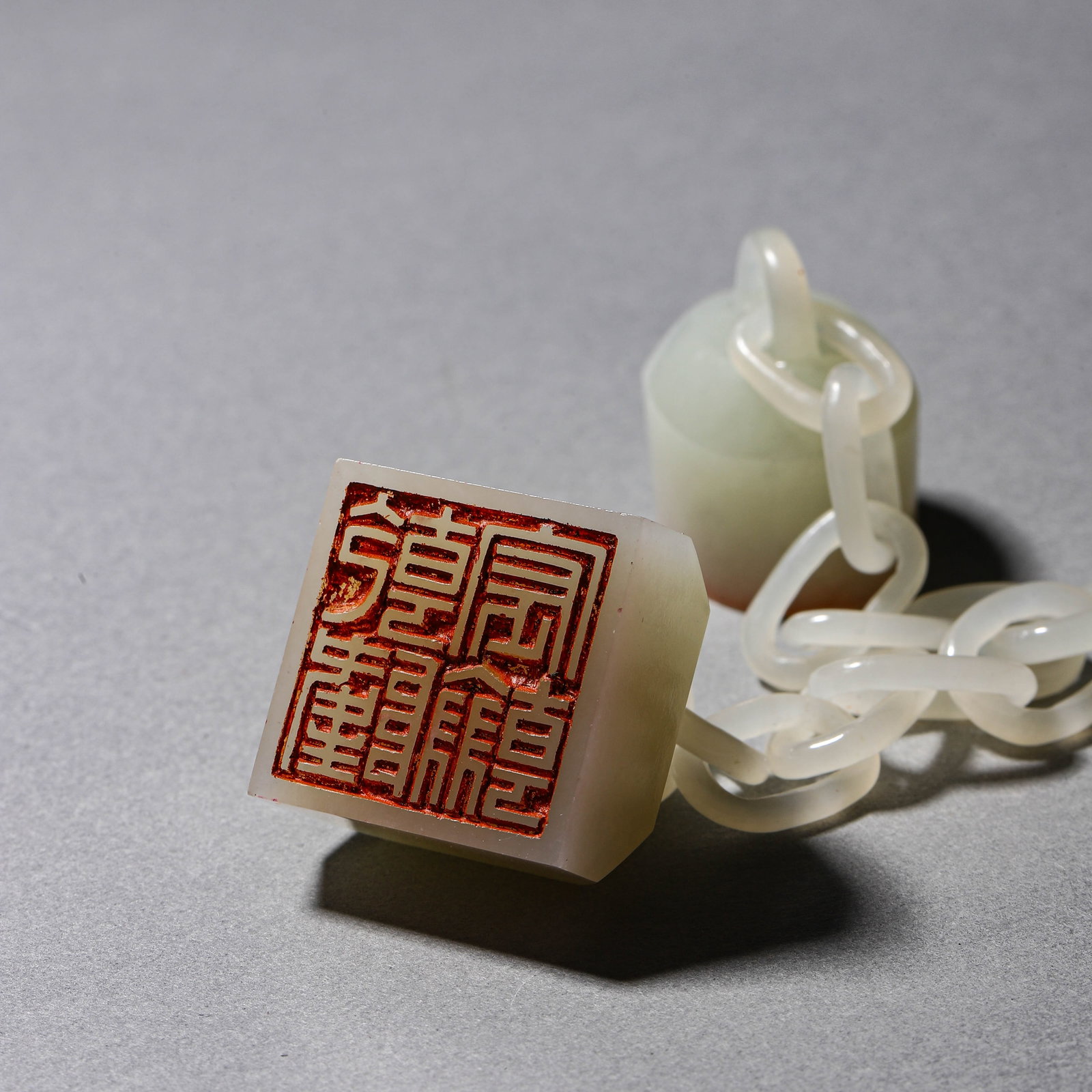 A WHITE JADE CHAINED TRIPLE SEAL - 3