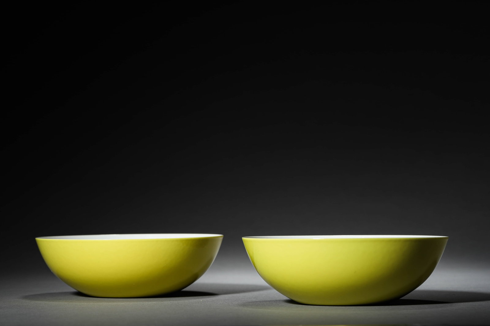 A PAIR OF YELLOW-GLAZED BOWLS: A PAIR OF YELLOW-GLAZED BOWLS Height: 1 5/8 in. (4 cm), Diameter: 5 1/8 in. (13 cm)