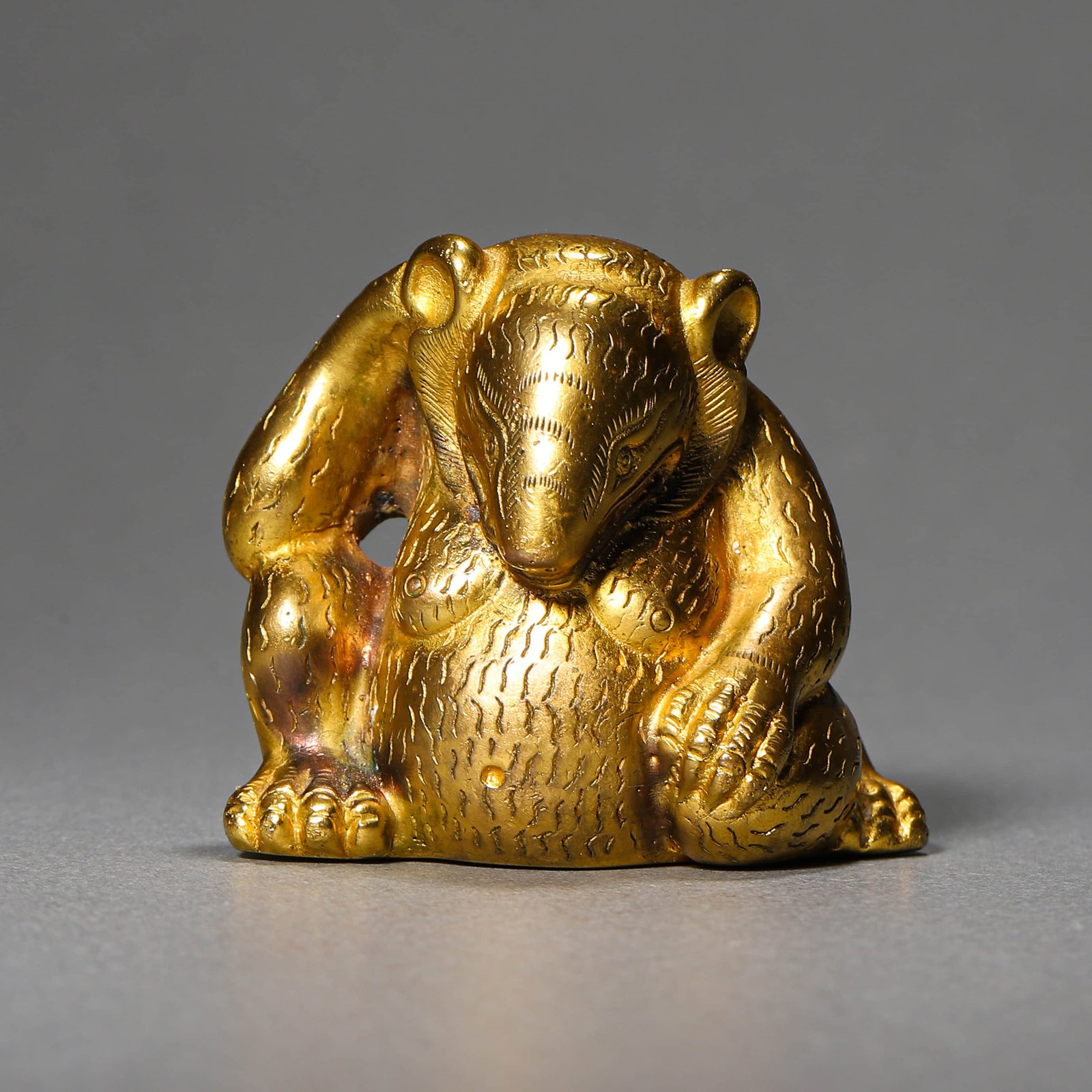 A GILT-BRONZE BEAR FIGURE: A GILT-BRONZE BEAR FIGURE Height: 1 7/8 in. (4.8 cm)