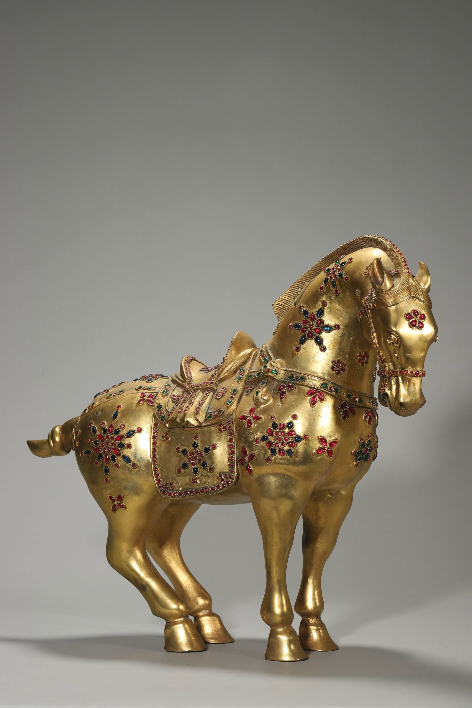 A GILT-BRONZE AND GEM-INLAID HORSE: A GILT-BRONZE AND GEM-INLAID HORSE Height: 15 13/16 in. (40.2 cm), Length: 16 15/16 in. (43 cm)