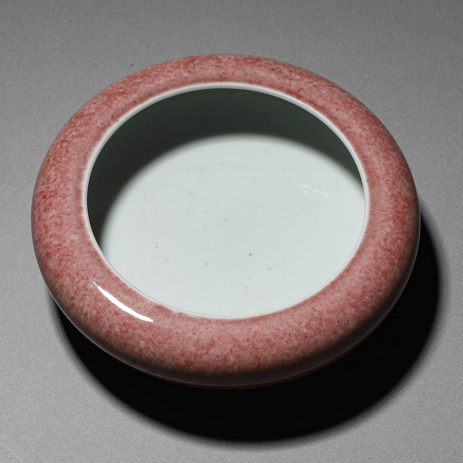 A LANGYAO RED-GLAZED WATER COUPE: A LANGYAO RED-GLAZED WATER COUPE Diameter: 4 7/8 in. (12.4 cm), Height: 1 3/8 in. (3.5 cm)