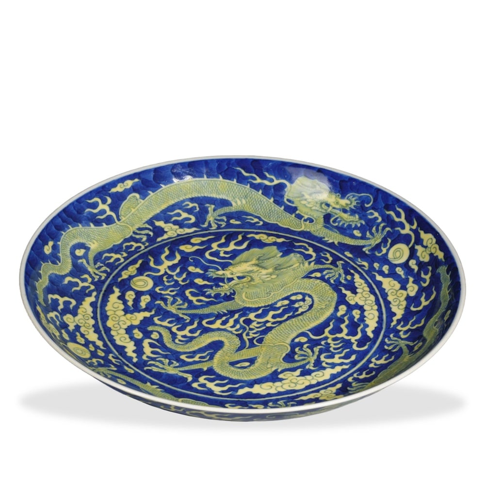 DAOGUANG YELLOW-ENAMELED 'CLOUD DRAGON' DISH ON BLUE GROUND: 1 5/8 x 10 3/8 in (4 x 26.5 cm) Daoguang Yellow-Enameled 'Cloud Dragon' Dish on Blue Ground Dimensions: D: 10 3/8 in (26.5 cm); H: 1 5/8 in (4 cm) This finely potted dish exemplifies the introspective