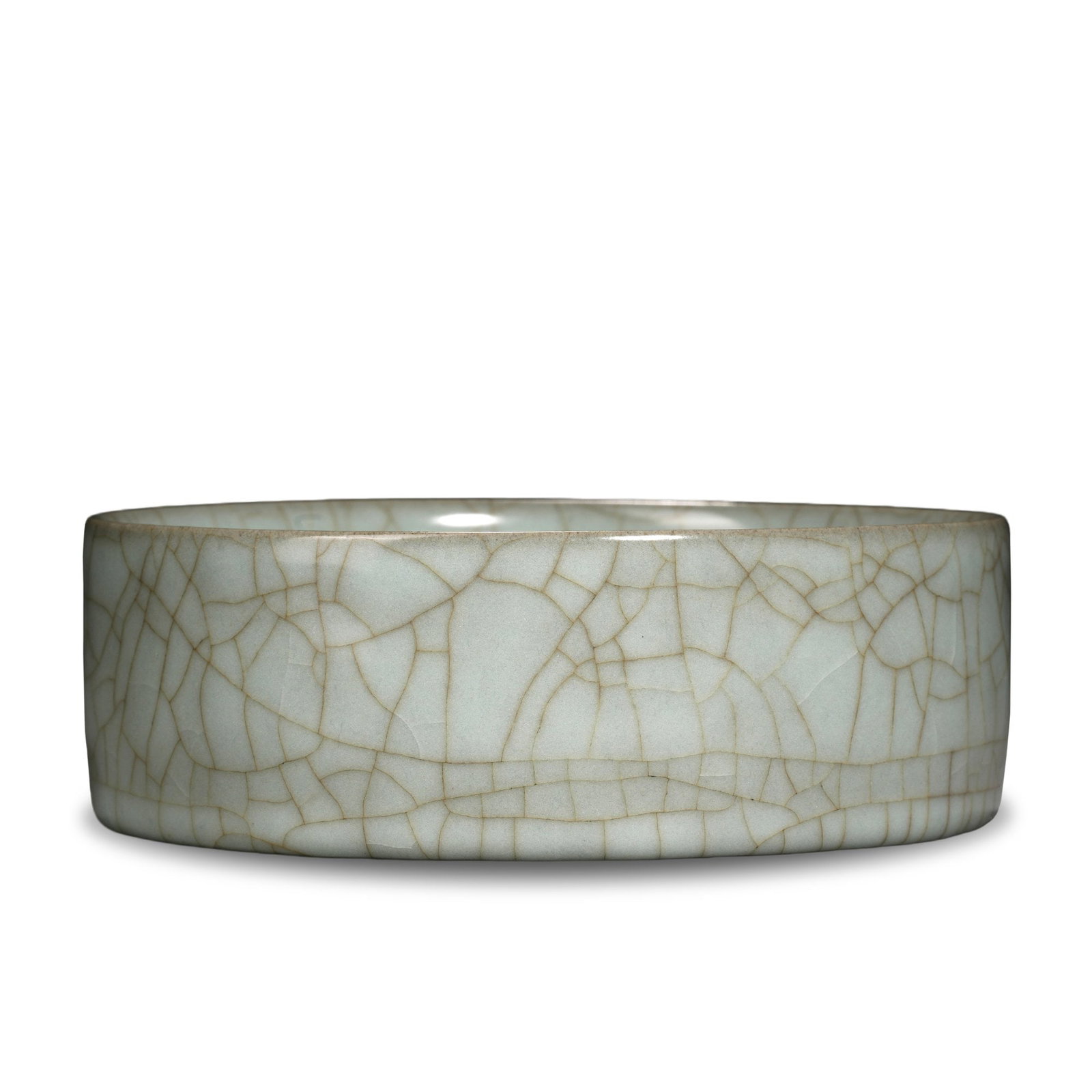 SONG DYNASTY GUAN WARE POWDER-GREEN GLAZED BRUSH WASHER: 2 x 5 7/8 in (5 x 15 cm) Song Dynasty Guan Ware Powder-Green Glazed Brush Washer Dimensions: D: 5 7/8 in (15 cm); H: 2 in (5 cm) This refined brush washer exemplifies the supreme aesthetic of Song