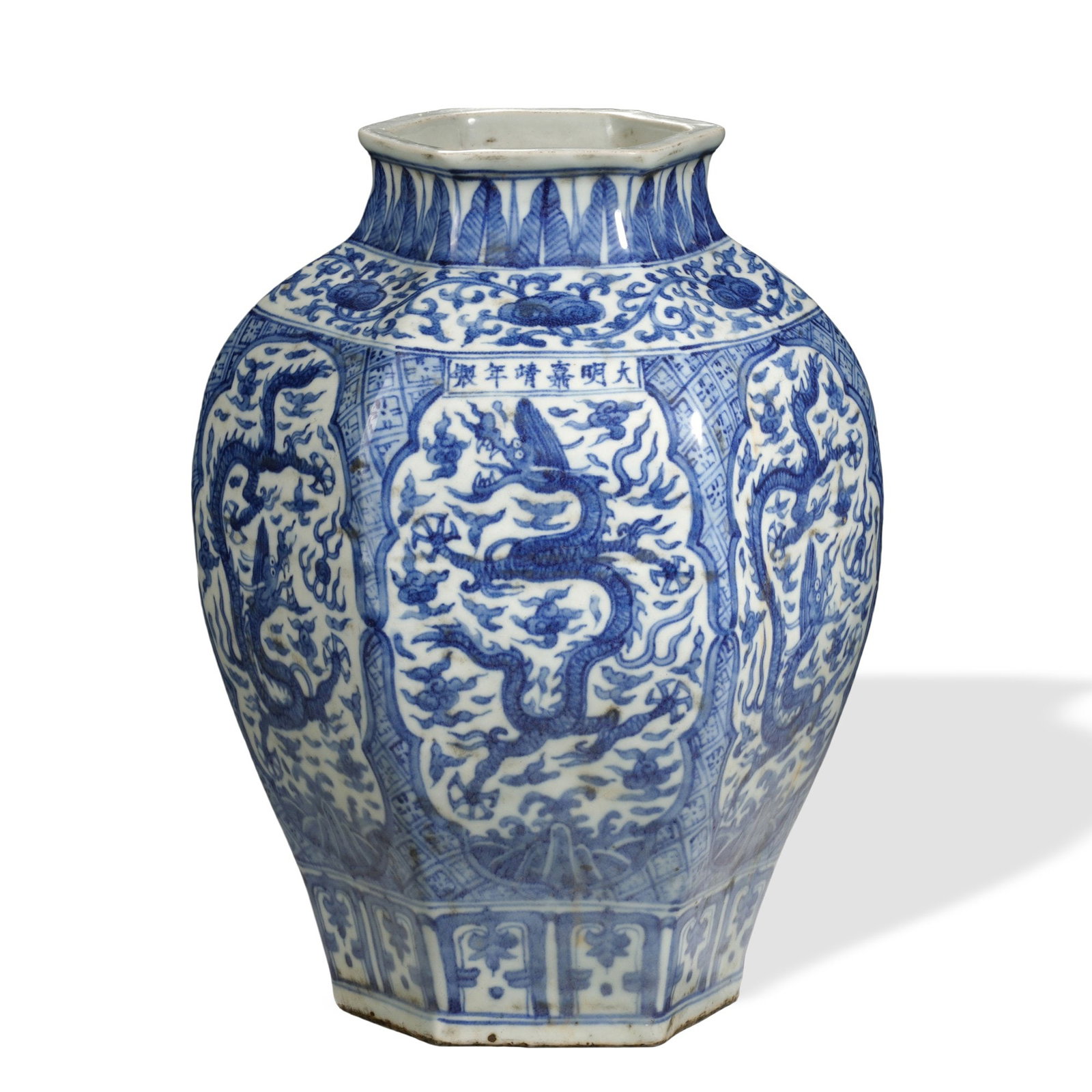 MING JIAJING BLUE AND WHITE 'DRAGON' HEXAGONAL VASE: 11 3/8 x 7 7/8 in (29 x 20 cm) Ming Jiajing Blue and White 'Dragon' Hexagonal Vase Dimensions: H: 11 3/8 in (29 cm); W: 7 7/8 in (20 cm) This impressive hexagonal vase exemplifies the distinctive