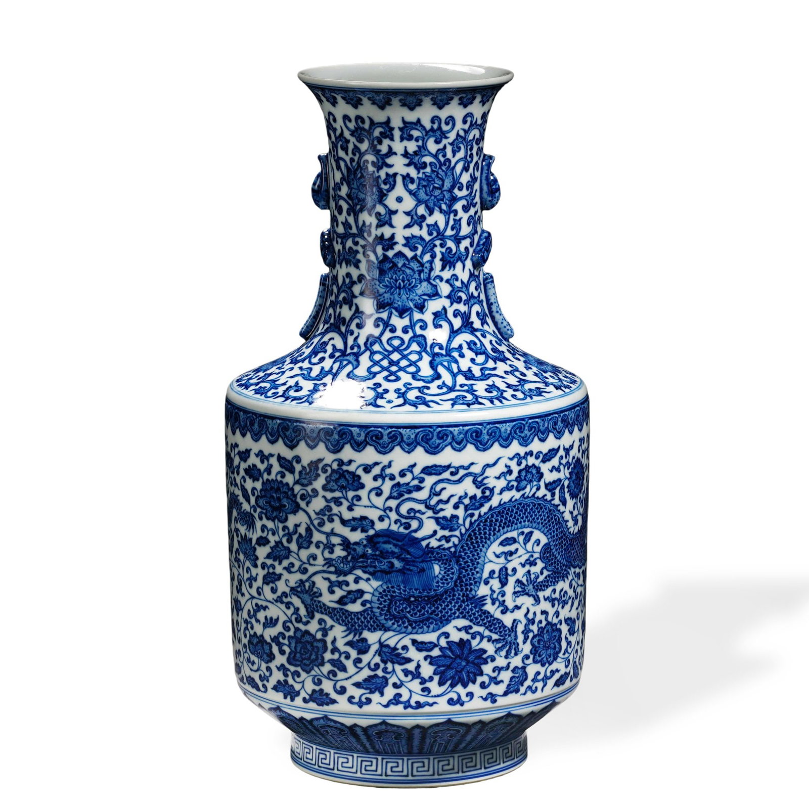 QIANLONG BLUE AND WHITE 'PEONY AND DRAGON' TWIN-HANDLED VASE: 16 1/2 x 8 1/4 in (42 x 21 cm) Qianlong Blue and White 'Peony and Dragon' Twin-Handled Vase Dimensions: H: 16 1/2 in (42 cm); W: 8 1/4 in (21 cm) This commanding vase exemplifies the precision of
