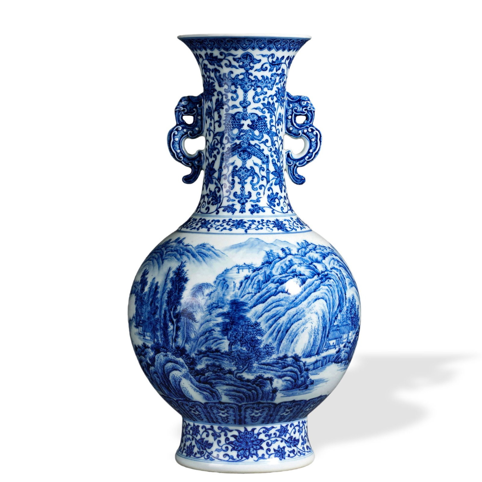 QIANLONG BLUE AND WHITE 'LANDSCAPE AND FIGURES' VASE WITH MYTHICAL-DRAGON HANDLES: 16 7/8 x 9 in (43 x 23 cm) Qianlong Blue and White 'Landscape and Figures' Vase with Mythical-Dragon Handles Dimensions: H: 16 7/8 in (43 cm); W: 9 in (23 cm) This commanding vase exemplifies the