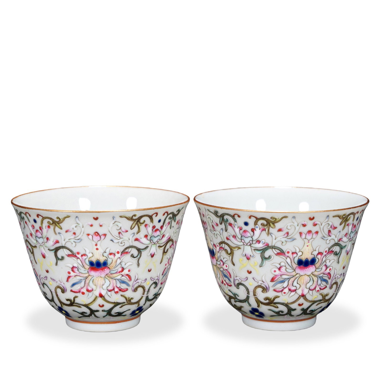 PAIR OF TONGZHI FAMILLE ROSE 'LOTUS SCROLL' CUPS: 2 1/8 x 2 3/4 in (5.5 x 7 cm) Pair of Tongzhi Famille Rose 'Lotus Scroll' Cups Dimensions: H: 2 1/8 in (5.5 cm); D: 2 3/4 in (7 cm) This refined pair of small cups exemplifies the late-Qing