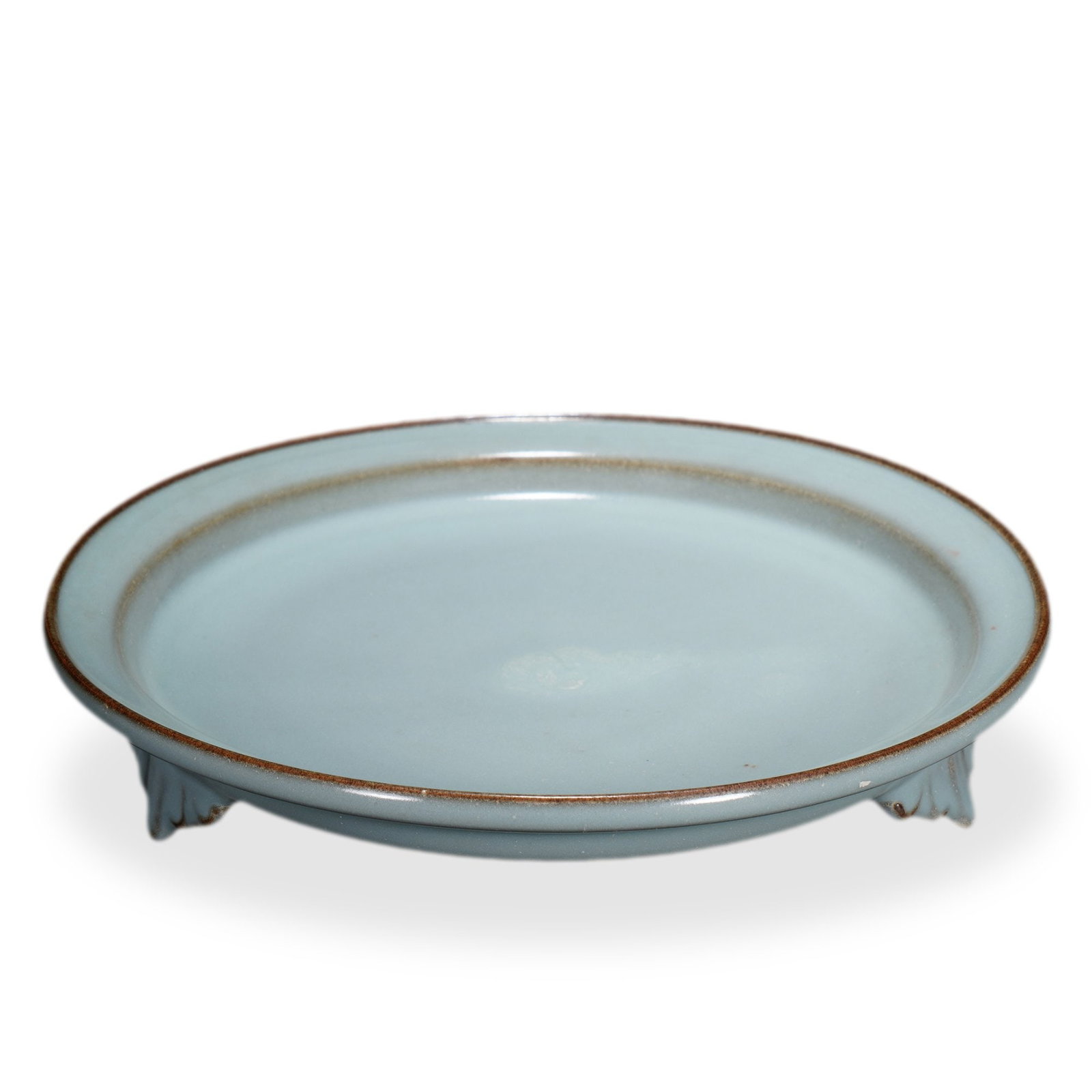 SONG DYNASTY LONGQUAN CELADON TRIPOD DISH: 1 3/8 x 7 7/8 in (3.5 x 20 cm) Song Dynasty Longquan Celadon Tripod Dish Dimensions: D: 7 7/8 in (20 cm); H: 1 3/8 in (3.5 cm) This refined dish exemplifies the supreme aesthetic of Song Longquan cela