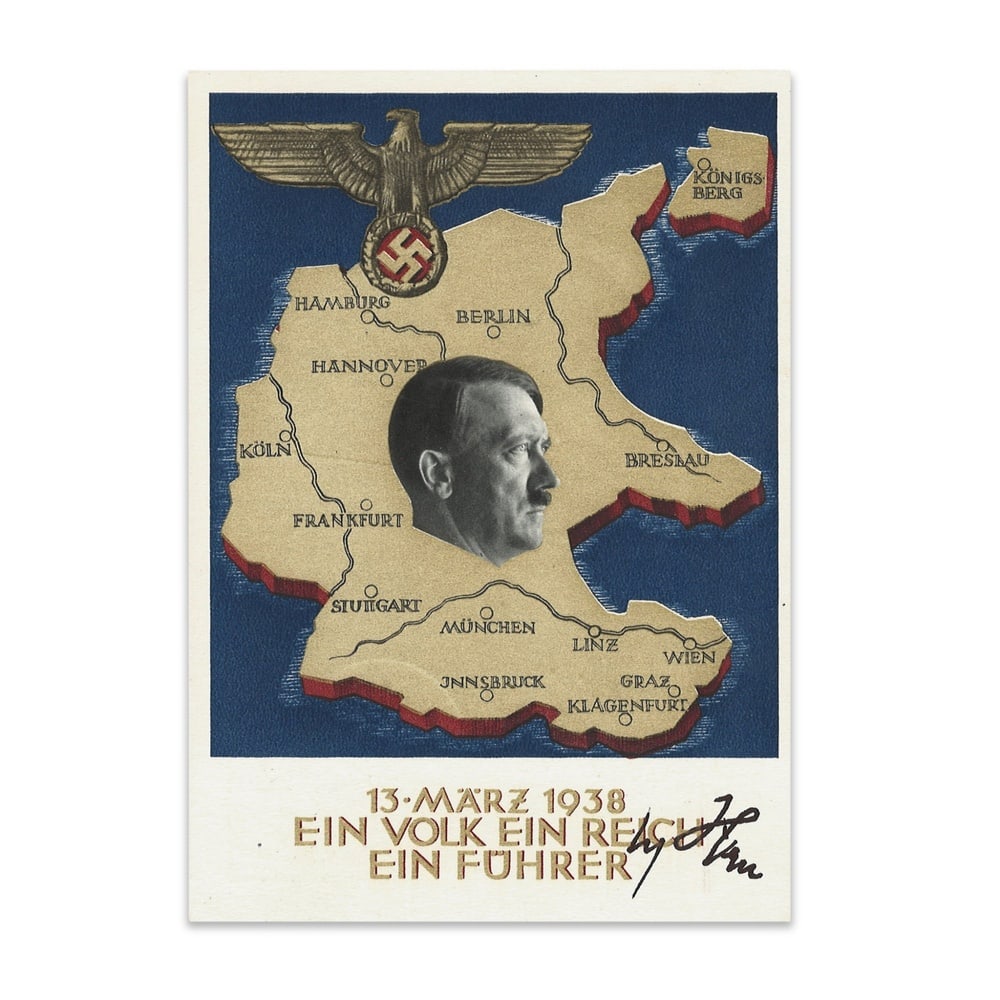 ADOLF HITLER SIGNED COMMEMORATIVE POSTCARD: 5 3/4 x 4 1/8 in (14.7 x 10.4 cm) This commemorative postcard relates to the 1938 Anschluss and features a period design incorporating a map of Germany, a portrait of Adolf Hitler, and the inscription