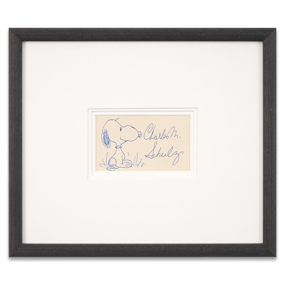 CHARLES M. SCHULZ SIGNED DRAWING - SNOOPY: Image Dimensions: 4 3/4 x 2 3/4 in (12 x 7 cm) Framed Dimensions: 13 3/4 x 11 3/4 in (35 x 30 cm) Provenance and Authentication: According to the Letter of Authenticity (LOA) and Certificate of Authen