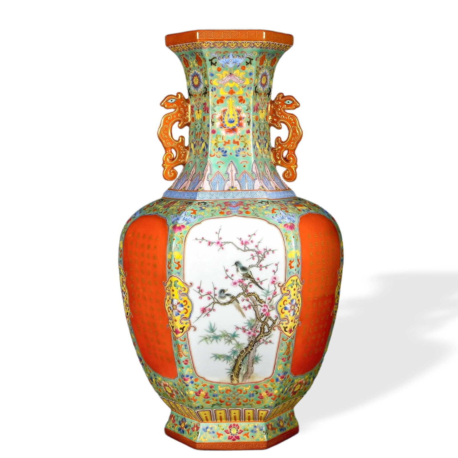 QIANLONG FAMILLE ROSE HEXAGONAL TWIN-HANDLED VASE WITH 'BIRDS AND PRUNUS' CARTOUCHES ON TURQUOISE: Qianlong Famille Rose Hexagonal Twin-Handled Vase with 'Birds and Prunus' Cartouches on Turquoise and Iron-Red Grounds Dimensions: H: 20 1/2 in (52 cm); W: 11 1/2 in (29 cm) This monumental hexagonal 