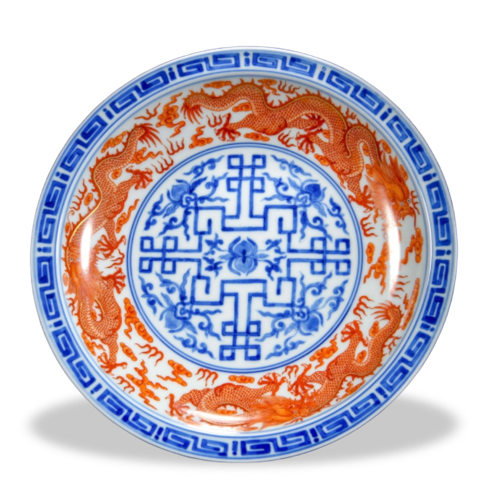 QIANLONG UNDERGLAZE BLUE AND IRON-RED 'DRAGONS AND GEOMETRIC MEDALLION' DISH: Qianlong Underglaze Blue and Iron-Red 'Dragons and Geometric Medallion' Dish Dimensions: H: 1 1/4 in (3 cm); D: 7 3/4 in (19.5 cm) This finely potted dish exemplifies the small-scale precision for
