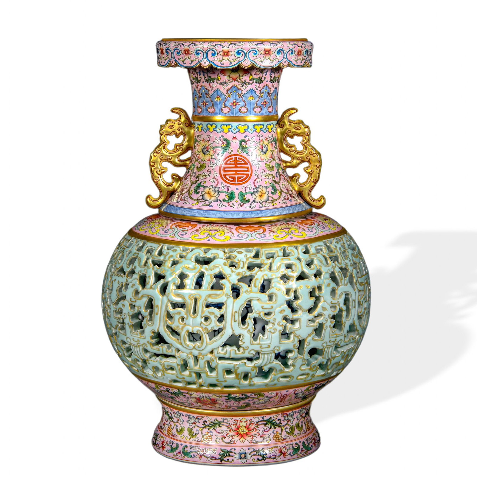 QIANLONG RETICULATED REVOLVING VASE WITH FAMILLE ROSE EXTERIOR, UNDERGLAZE BLUE INTERIOR, AND CARVED: Qianlong Reticulated Revolving Vase with Famille Rose Exterior, Underglaze Blue Interior, and Carved Celadon Openwork Dimensions: H: 16 1/4 in (41 cm); W: 12 1/4 in (31 cm) This monumental reticulated