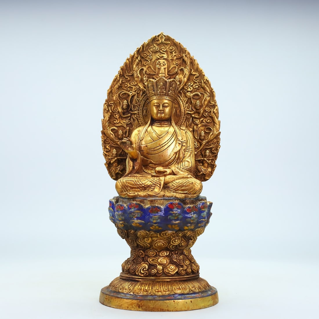 Gilded bronze relief cloisonne seated Buddha figurine: A gilt bronze cloisonne seated Buddha statue, 36cm high, 16cm wide, and weighing 3262g. Thank you for viewing our auction and we look forward to serving you as a valued customer! Provenance:The Proper