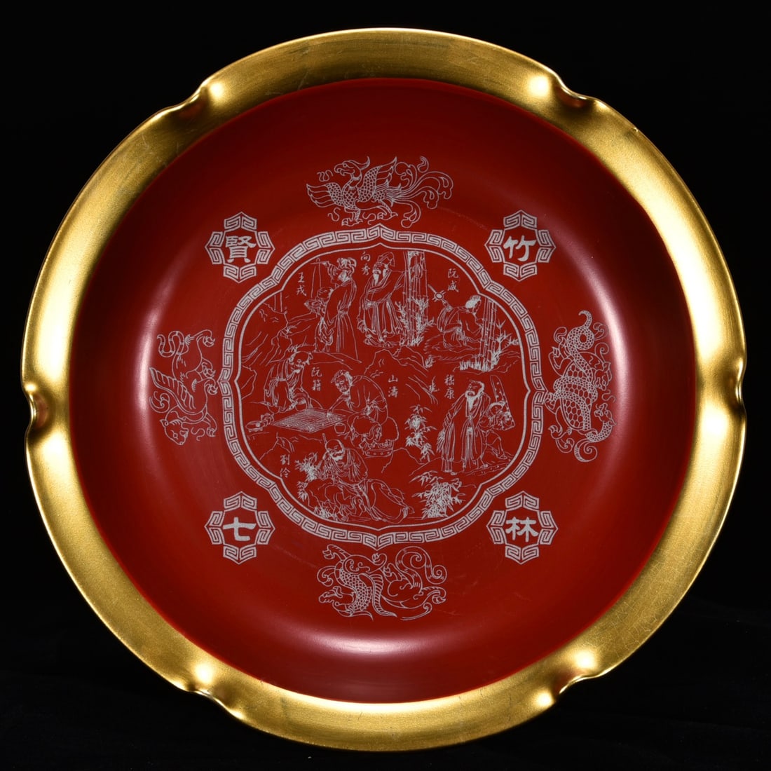 Song Dynasty Ru ware celadon-glazed gilt lacquerware plate with carved figures of the Seven Sages of: A Song Dynasty Ru ware celadon-glazed gilt lacquerware dish with carved figures of the Seven Sages of the Bamboo Grove, 5cm high and 29cm in diameter. Thank you for viewing our auction and we look for