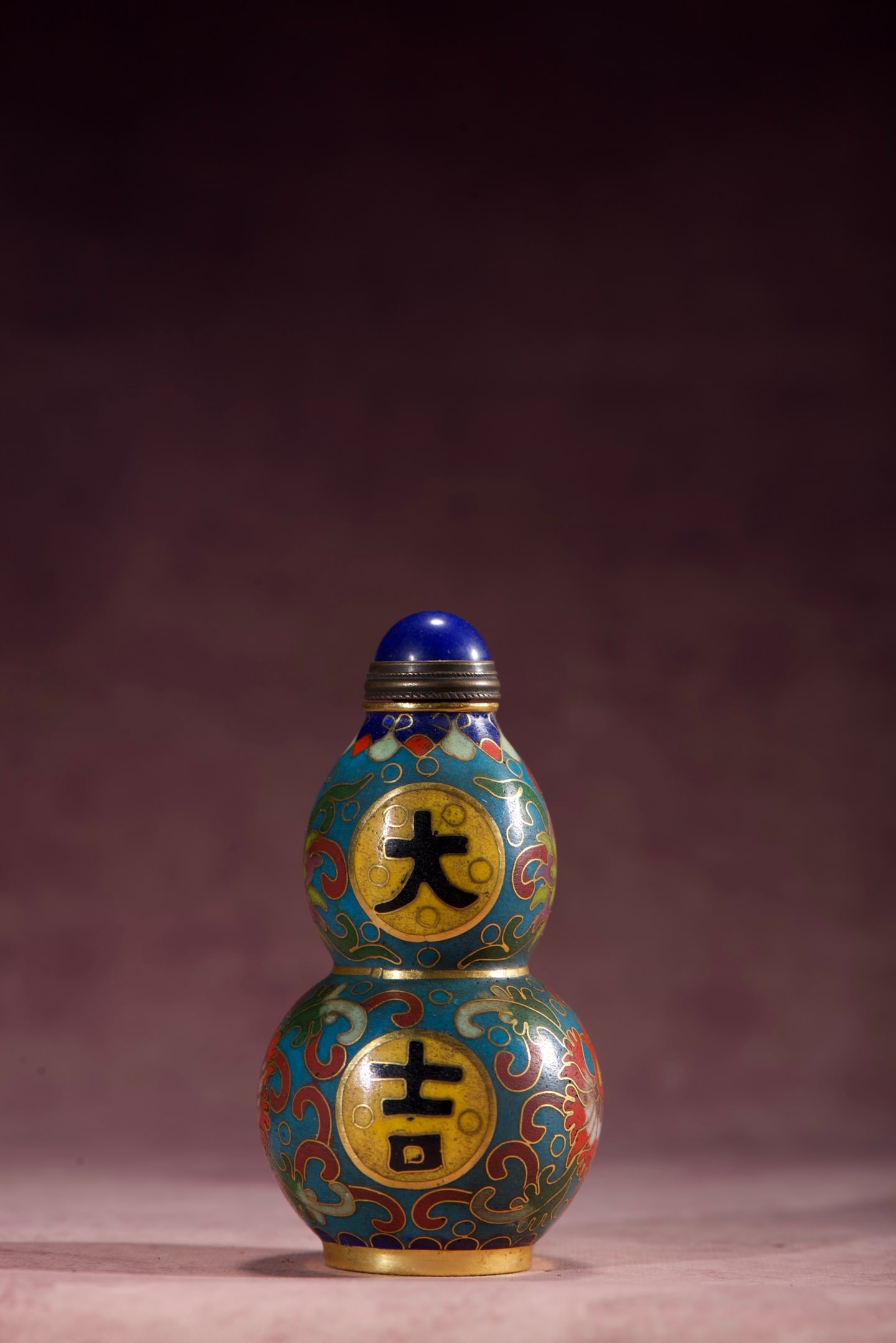 Auspicious Copper Cloisonne Enamel Gourd Snuff Bottle: A copper-bodied cloisonne enamel gourd-shaped snuff bottle with auspicious design, measuring 79mm in height, 42mm in diameter, and weighing 71g. Thank you for viewing our auction and we look forward