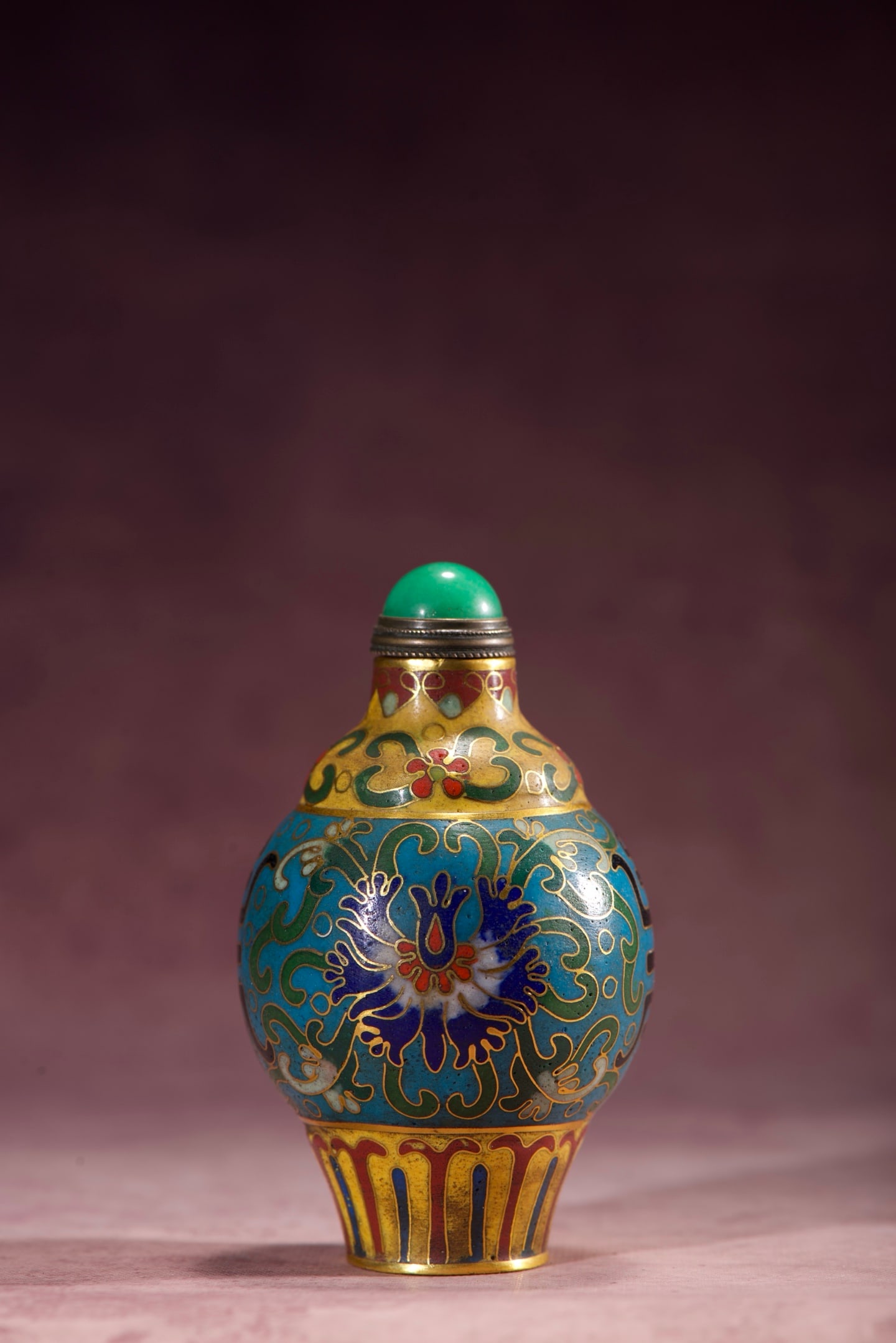 Copper-bodied cloisonne enamel snuff bottle with lotus and longevity character design: A copper-bodied cloisonne enamel snuff bottle with a design of lotus scrolls and the character for longevity. It is 81mm high, 49mm wide, and weighs 69g. Thank you for viewing our auction and we look