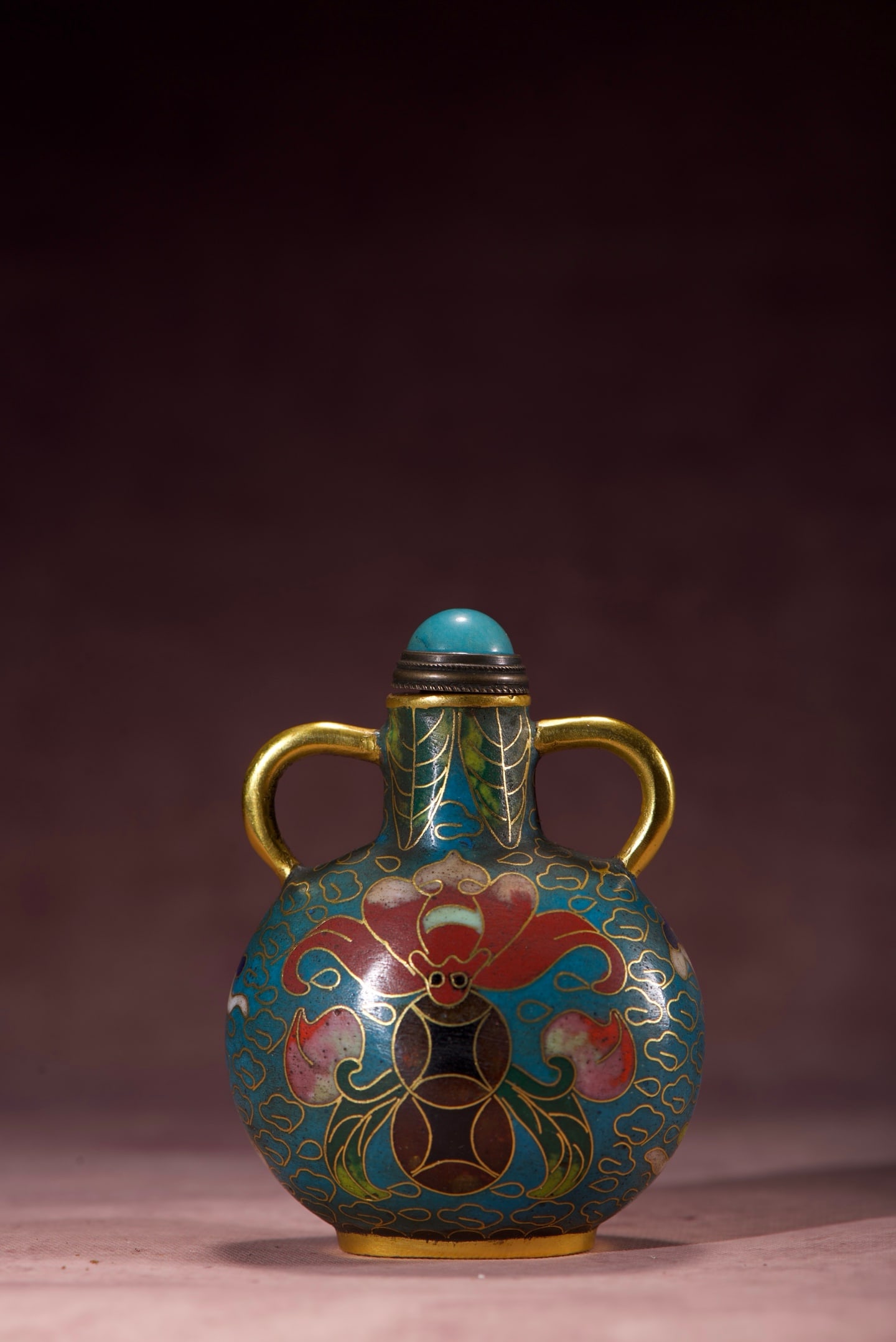 Copper-bodied cloisonne enamel snuff bottle with auspicious and longevity motifs and two handles: A copper-bodied cloisonne enamel snuff bottle with auspicious and longevity motifs and two handles. Height: 73mm, Width: 55mm, Thickness: 40mm, Weight: 74g. Thank you for viewing our auction and we