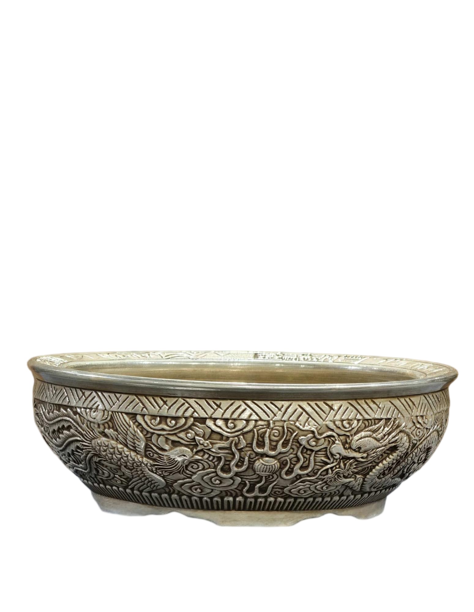 A silver-gilt porcelain treasure basin with high relief carving of dragon and phoenix design, dating: A silver-gilt porcelain treasure basin with high-relief dragon and phoenix design, bearing the mark of the Guangxu period, from a former collection. Exquisitely crafted and well-preserved. Thank you f