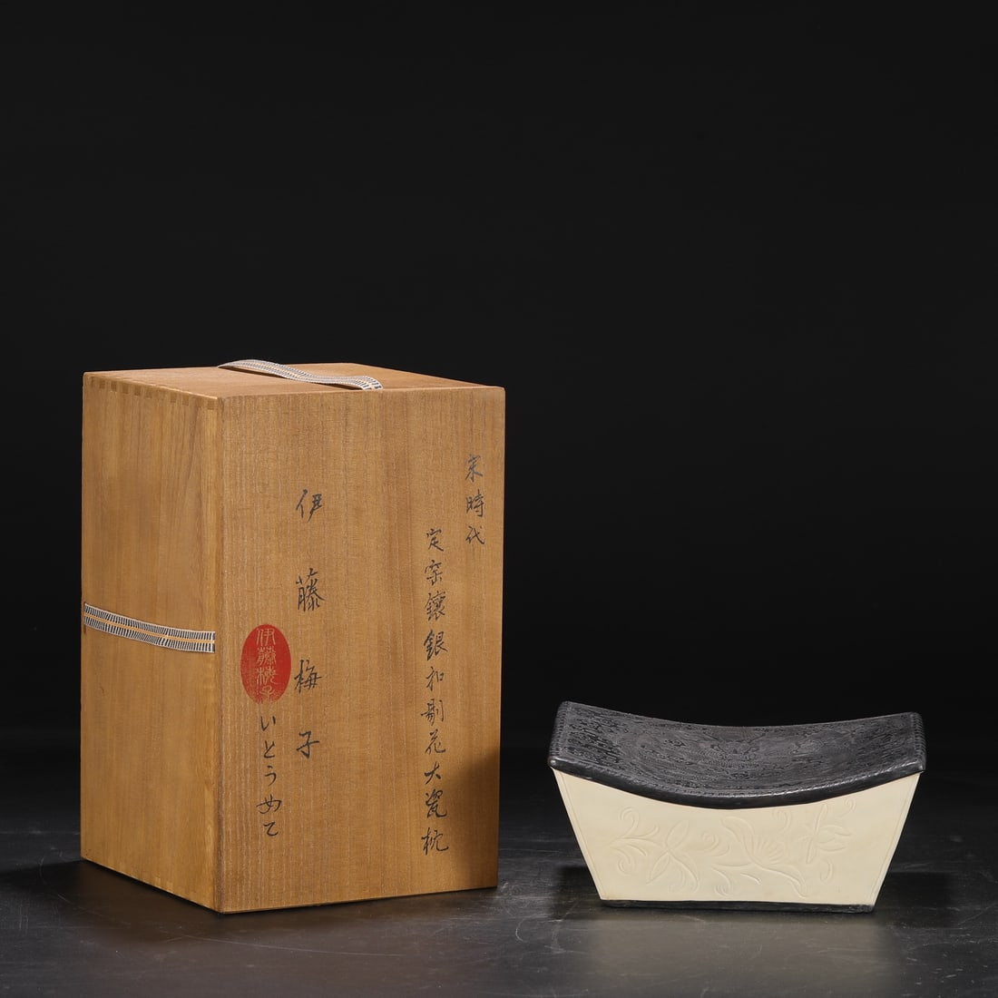 A large Northern Song Dynasty Ding ware white-glazed pillow with carved water ripple and duck: large Ding ware pillow from the Northern Song Dynasty (Ding kiln), formerly in the collection, with a white glaze, carved with a wave and duck motif, and inlaid with silver-engraved cloud and dragon p