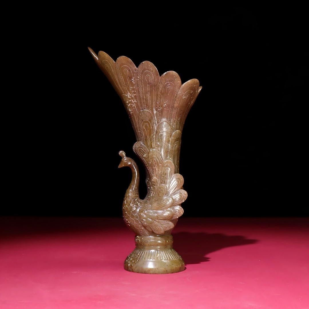 Exquisite antique piece, a Hetian jade phoenix-shaped vase with inlaid patterns.: A finely crafted, antique Hetian jade phoenix-shaped vase with a rich, deep patina, showcasing exquisite craftsmanship and sharp carving. A rare and exceptional piece from a private collection. Dimens