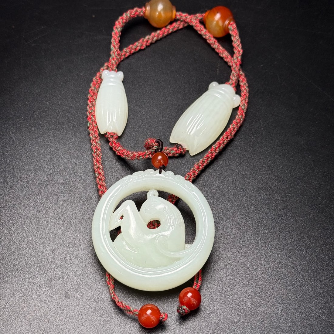 Fine Hetian jade accessories: This exquisite Hetian jade pendant features a hollowed-out horse carving, symbolizing success and advancement. It is complemented by two jade cicadas, signifying wealth and prosperity. The overall des